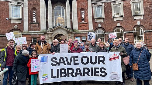 Lib Dem Campaigners standing in front of the York Explore, campaigning against cuts to the city's library service