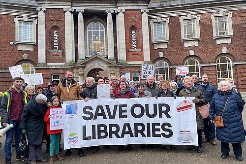 Lib Dem Campaigners standing in front of the York Explore, campaigning against cuts to the city's library service