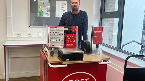 Photo of Cllr Hollyer with the temporary Post Office on wheels