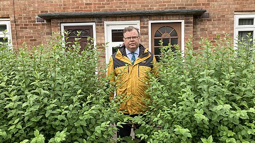 Cllr Waller with one of the overgrown hedges on Ascot Way