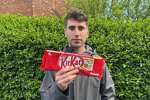 Cllr Smalley holding a packet of KitKats