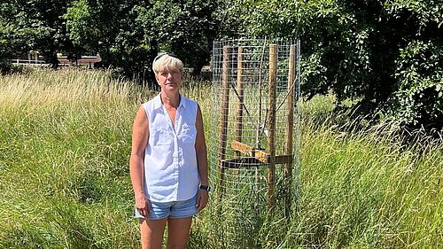 Cllr Widdowson with one of the dead trees prior to its removal